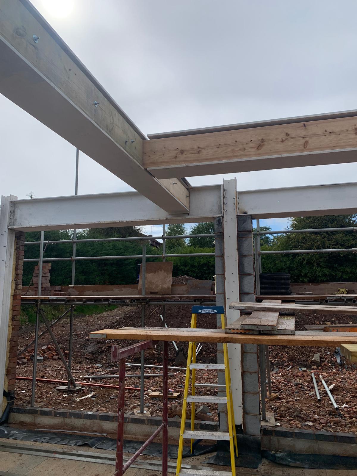 Steel beams supporting a large opening during extension construction