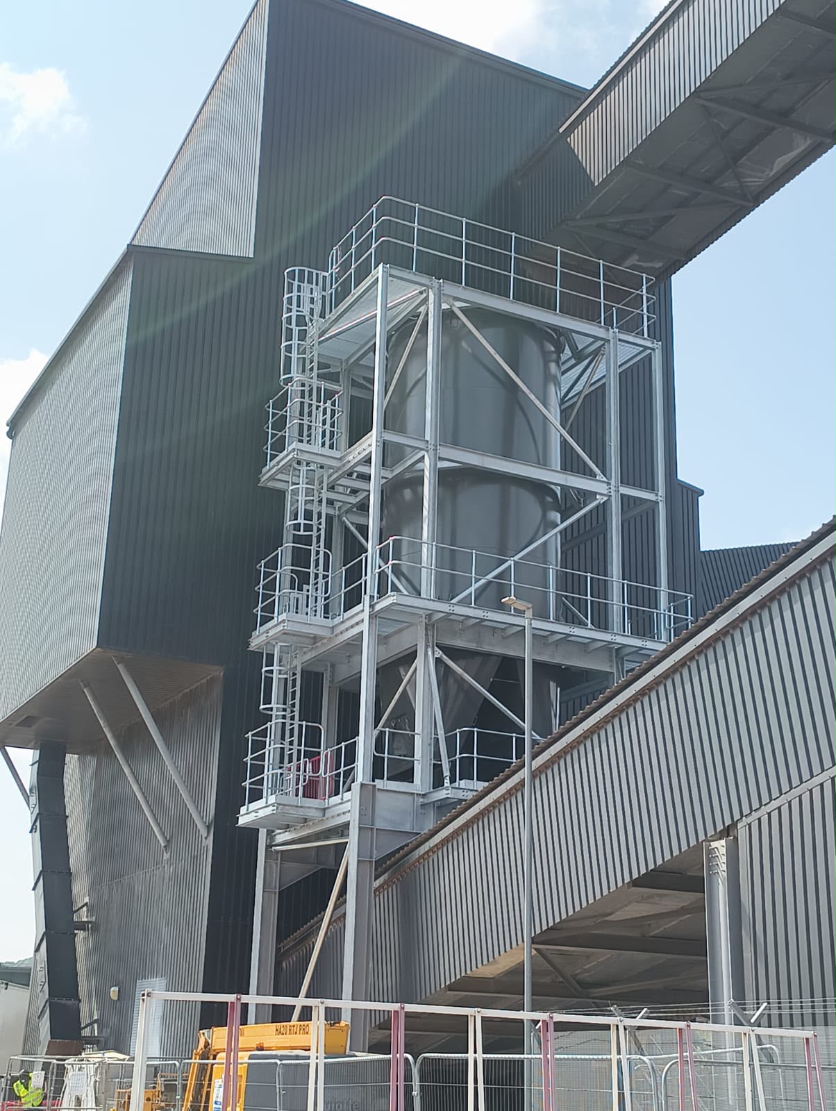 Industrial storage silo supported by structural steel framework